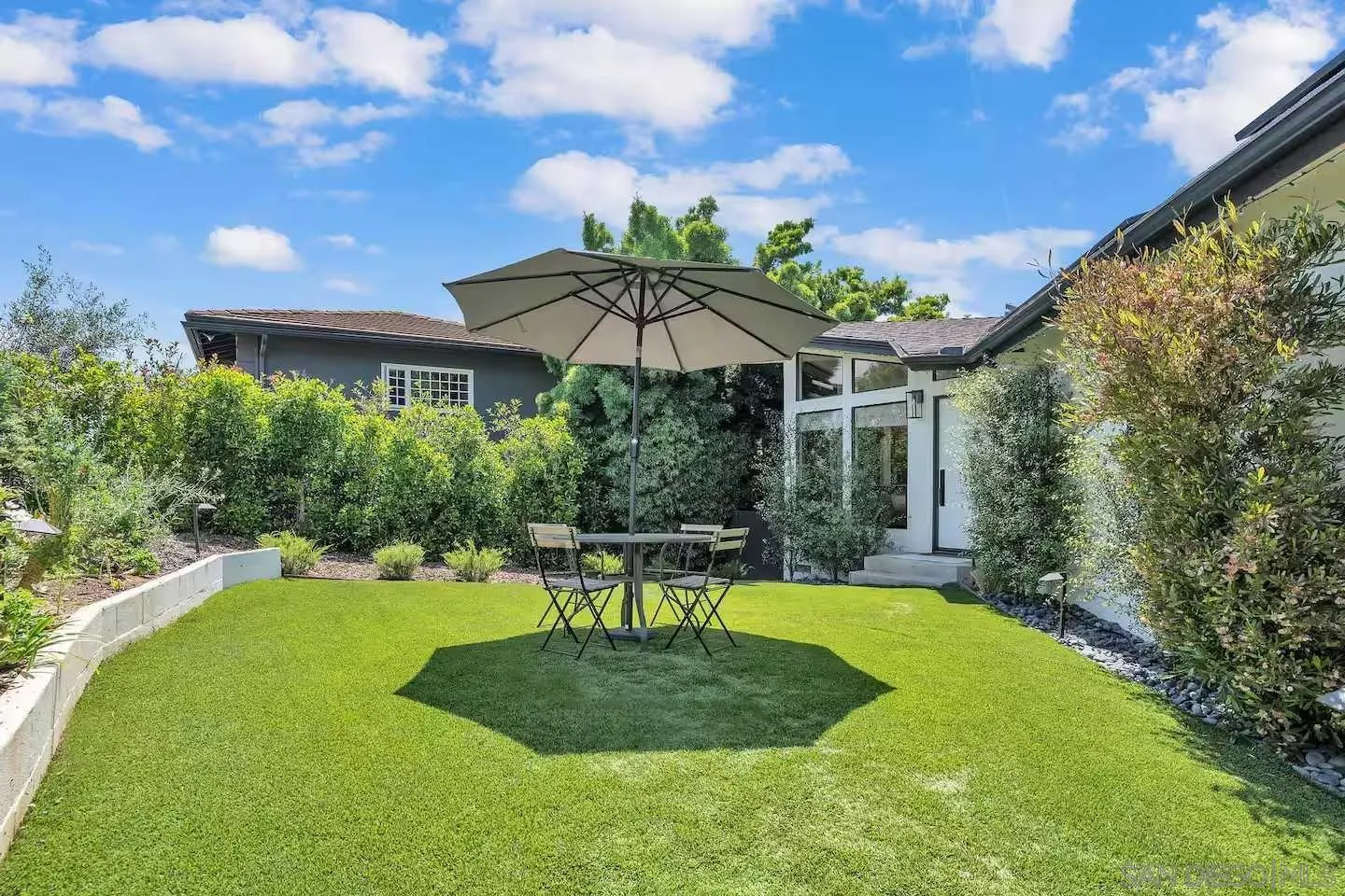 3550 Laketree Drive Fallbrook, CA 92028 - Photo 34 of 56 a view of a chair and table under an umbrella in backyard