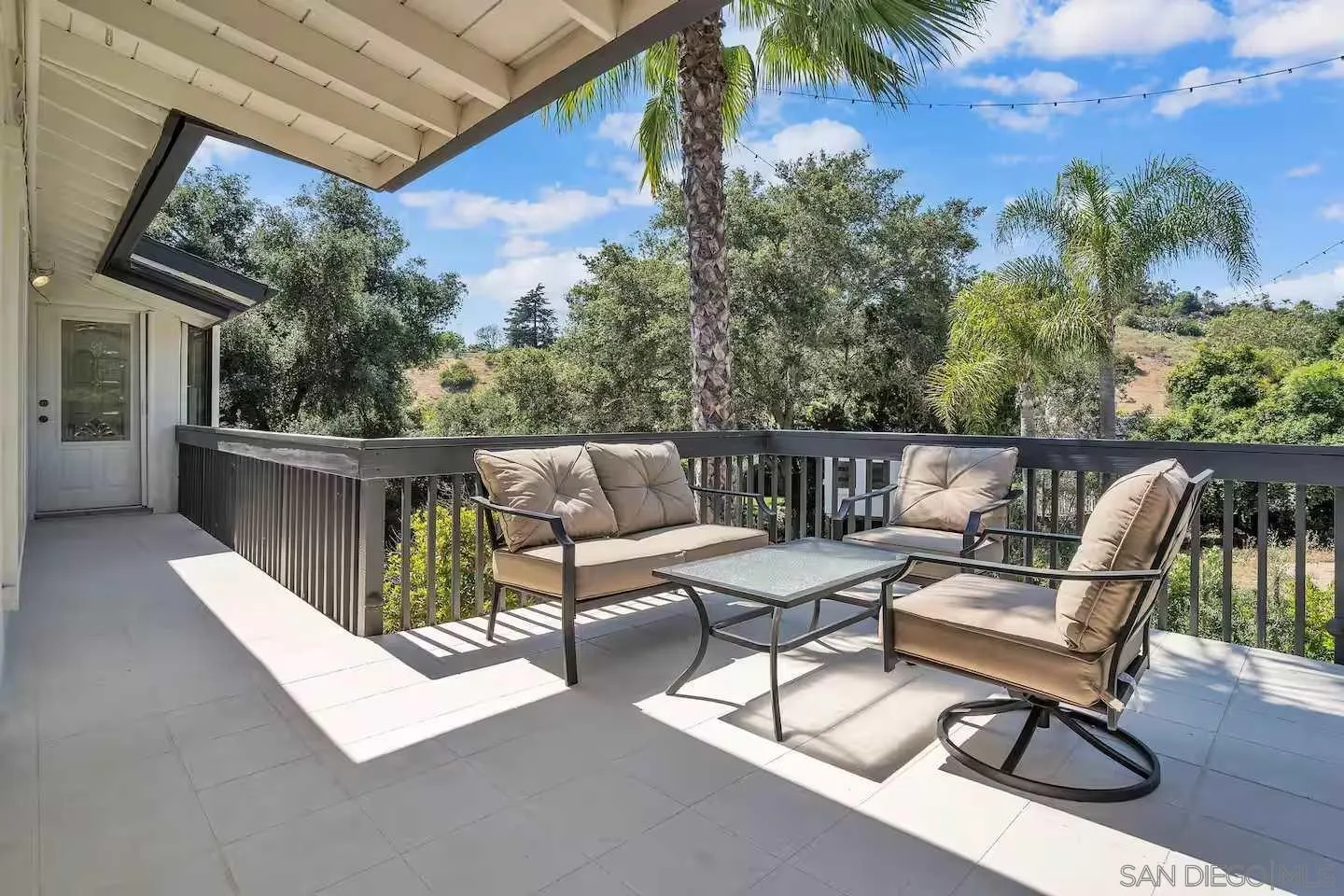 3550 Laketree Drive Fallbrook, CA 92028 - Photo 37 of 56 a roof deck with table and chairs and potted plants