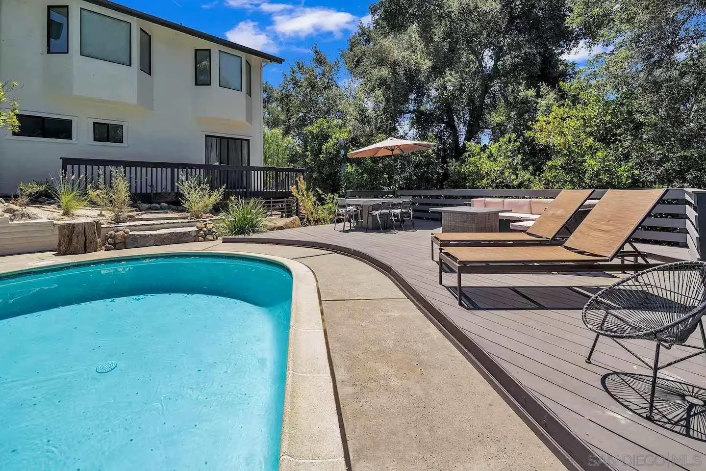 3550 Laketree Drive Fallbrook, CA 92028 - Photo 39 of 56 a view of a swimming pool with lounge chairs