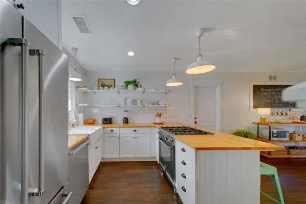 a view of a kitchen with a sink stainless steel appliances and cabinets