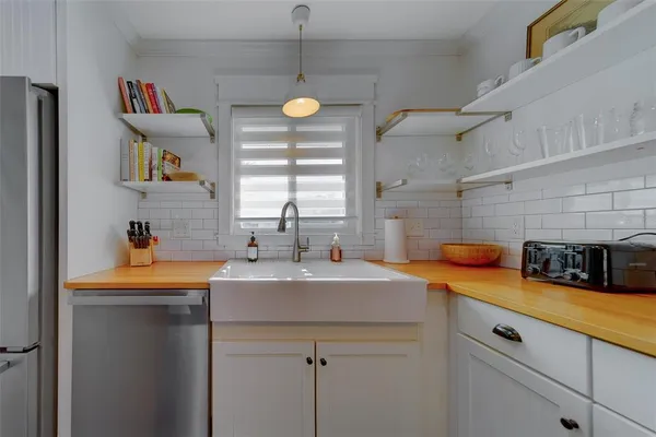 a kitchen with a sink a stove and cabinets