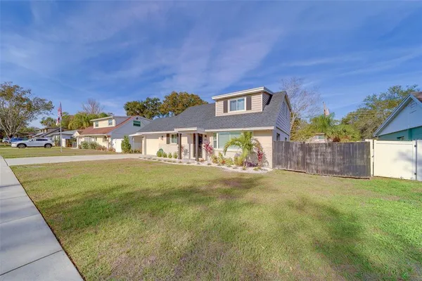 a view of a house with a yard and garage