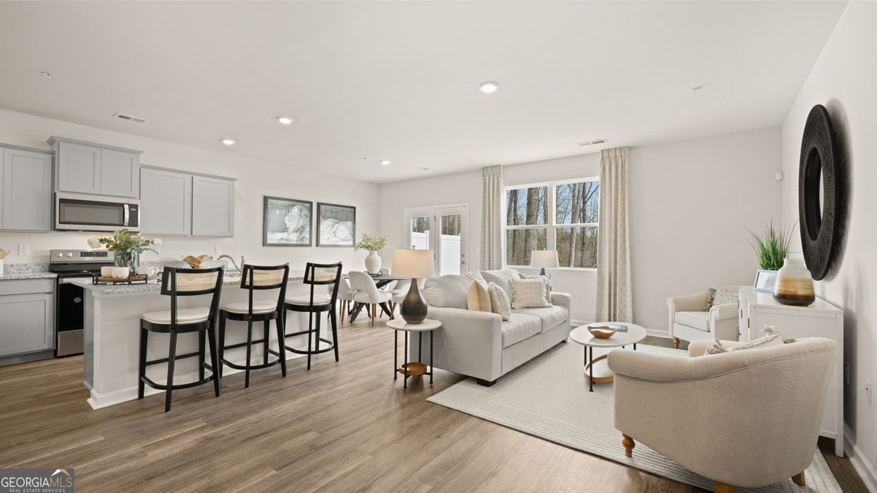 266 Sound Circle Stockbridge, GA 30281 - Photo 15 of 39 a living room with furniture and a flat screen tv