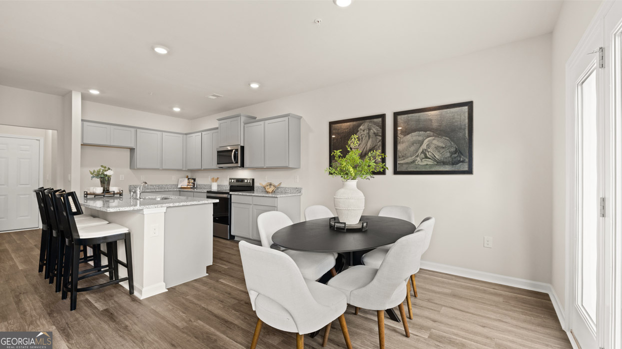 266 Sound Circle Stockbridge, GA 30281 - Photo 17 of 39 a kitchen with a dining table chairs and refrigerator