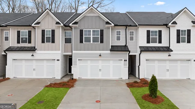 a view of a white house with a yard