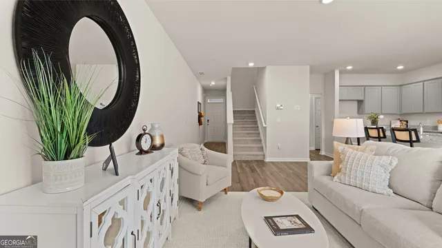 a living room with furniture and a mirror