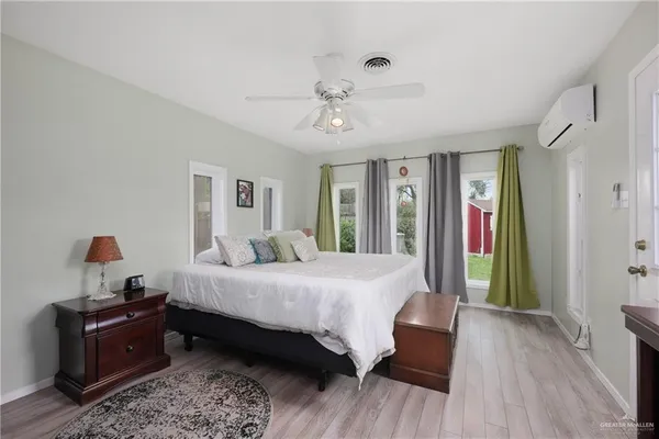 a bedroom with a large bed and a chandelier