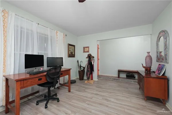 a view of a workspace with furniture and a window