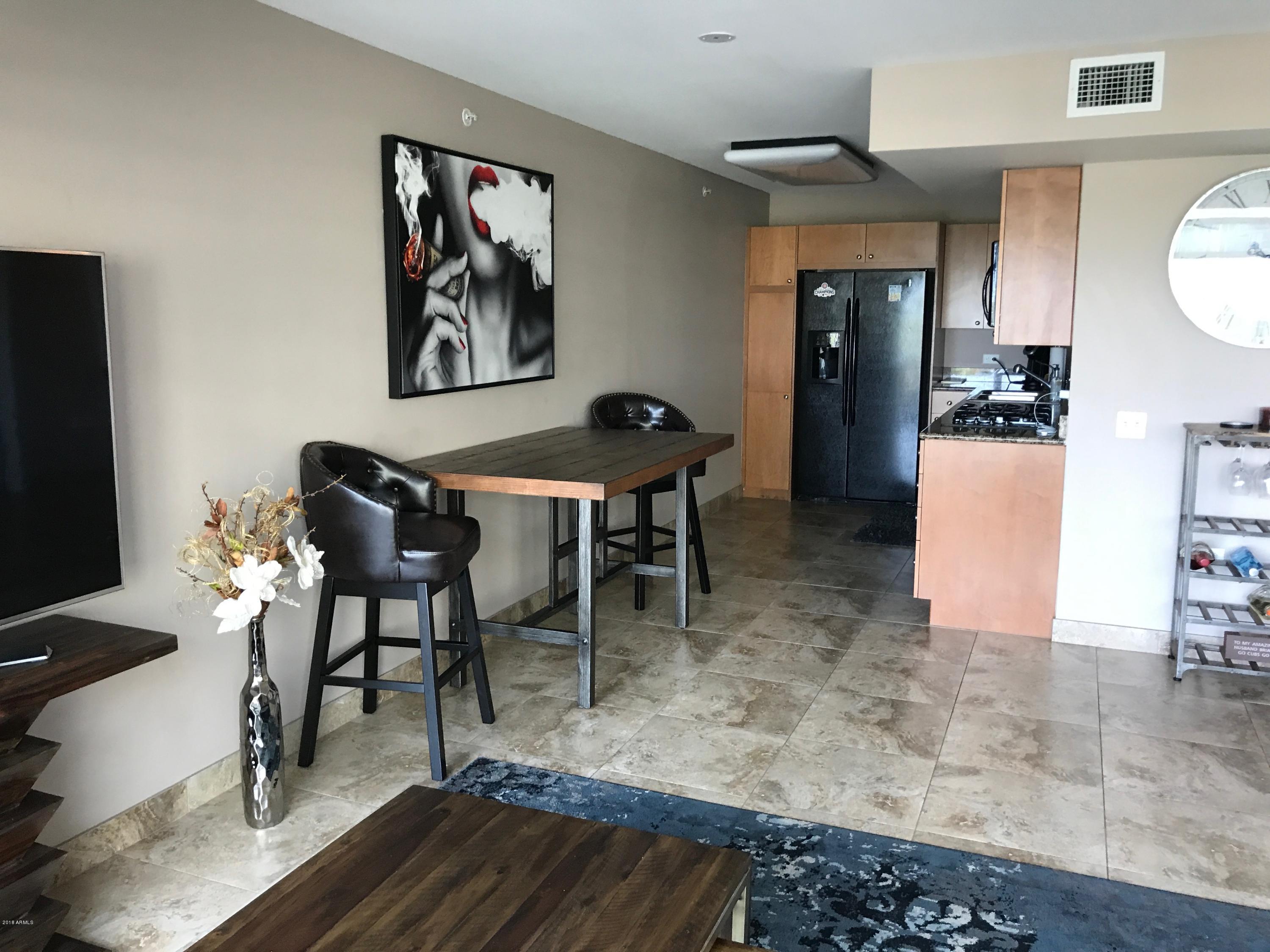 4808 North 24th Street, Unit 606 Phoenix, AZ 85016 - Photo 3 of 11 a view of a dining room with furniture and wooden floor