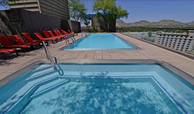 swimming pool view with a seating space