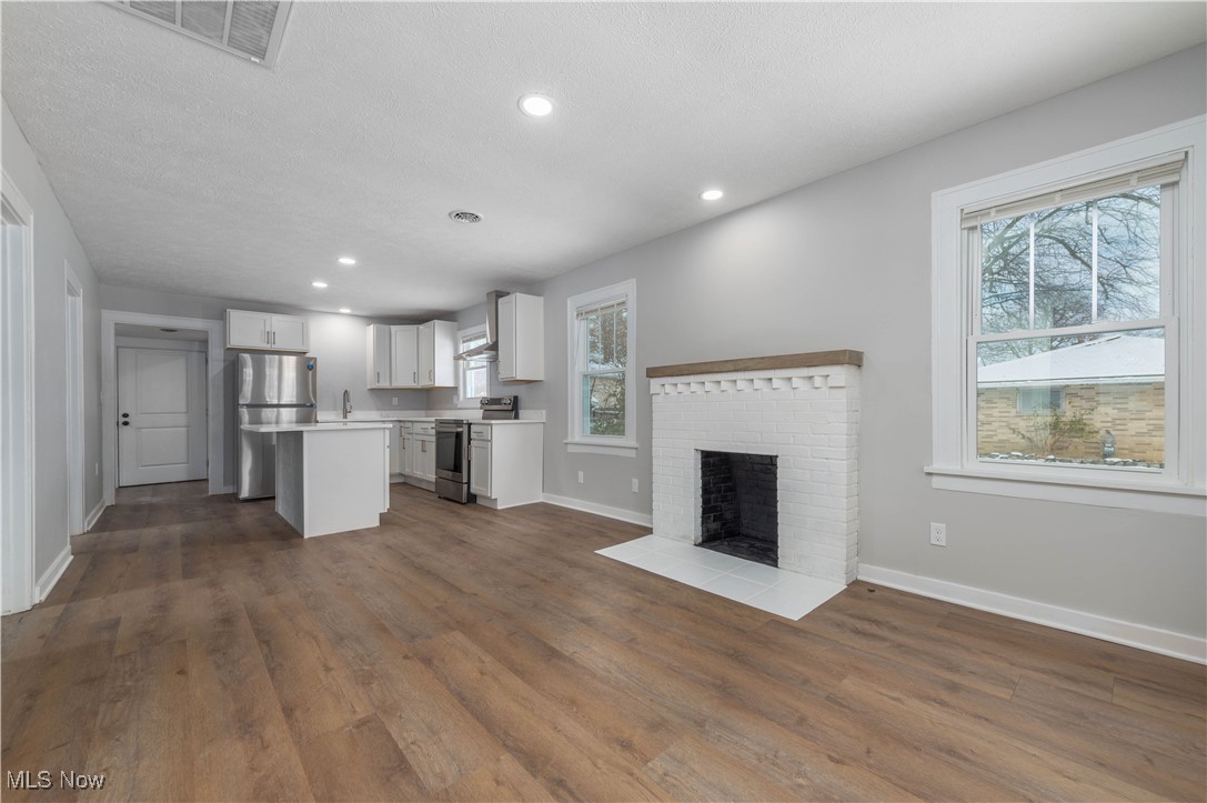 218 Roxboro Road Vermilion, OH 44089 - Photo 50 of 50 Kitchen with open floor plan, a center island, light countertops, white cabinets, and appliances with stainless steel finishes