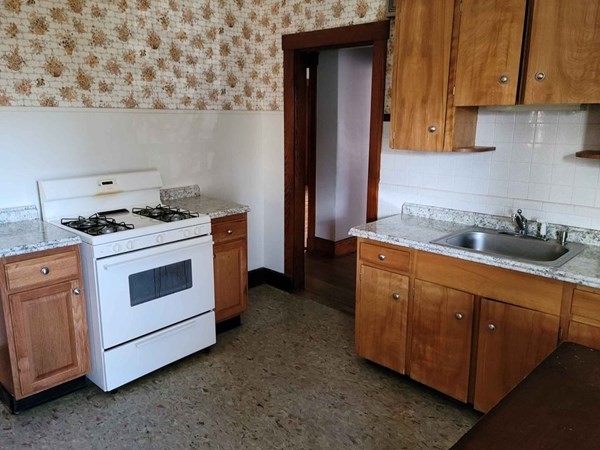 57 Austin Street, Unit 2 Boston, MA 02136 - Photo 15 of 17 a kitchen with stainless steel appliances granite countertop a stove and a refrigerator