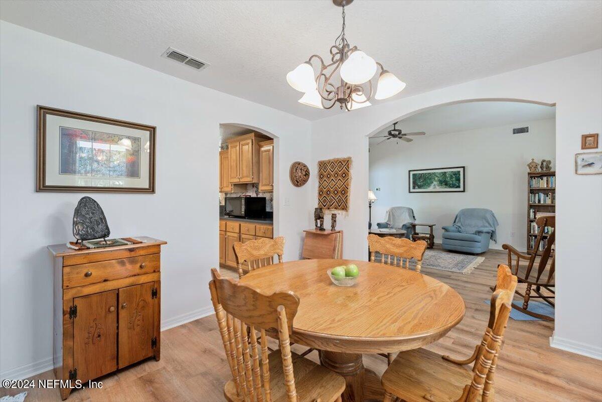 6481 Brooklyn Bay Road Keystone Heights, FL 32656 - Photo 12 of 45 a view of a dining room with furniture and wooden floor