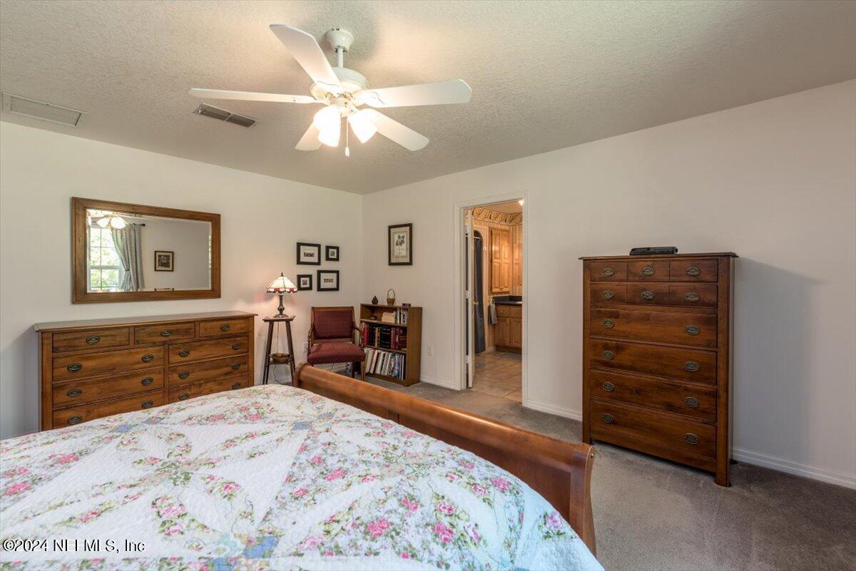 6481 Brooklyn Bay Road Keystone Heights, FL 32656 - Photo 21 of 45 a bed room with a bed and a television