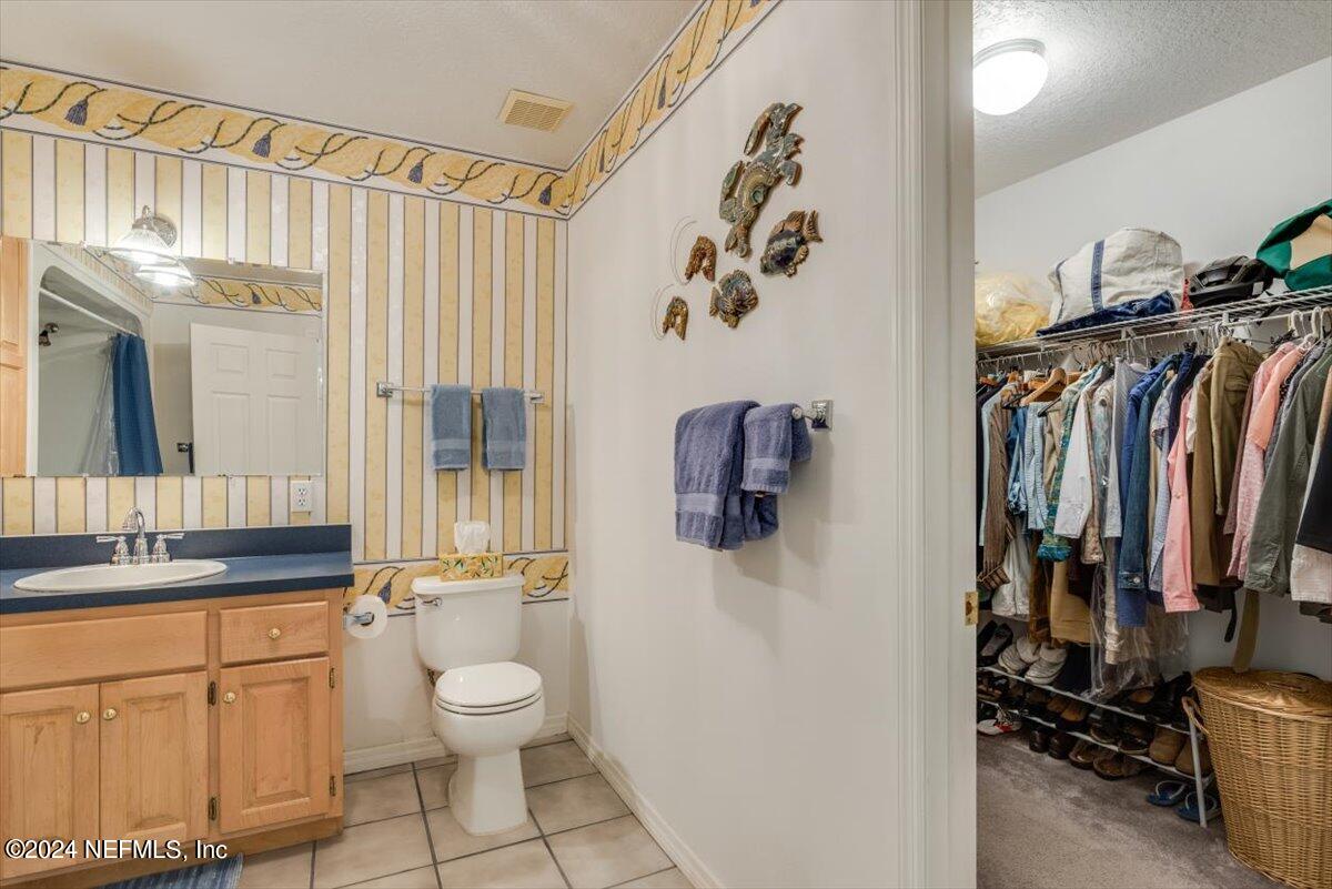 6481 Brooklyn Bay Road Keystone Heights, FL 32656 - Photo 23 of 45 a bathroom with a toilet sink and mirror