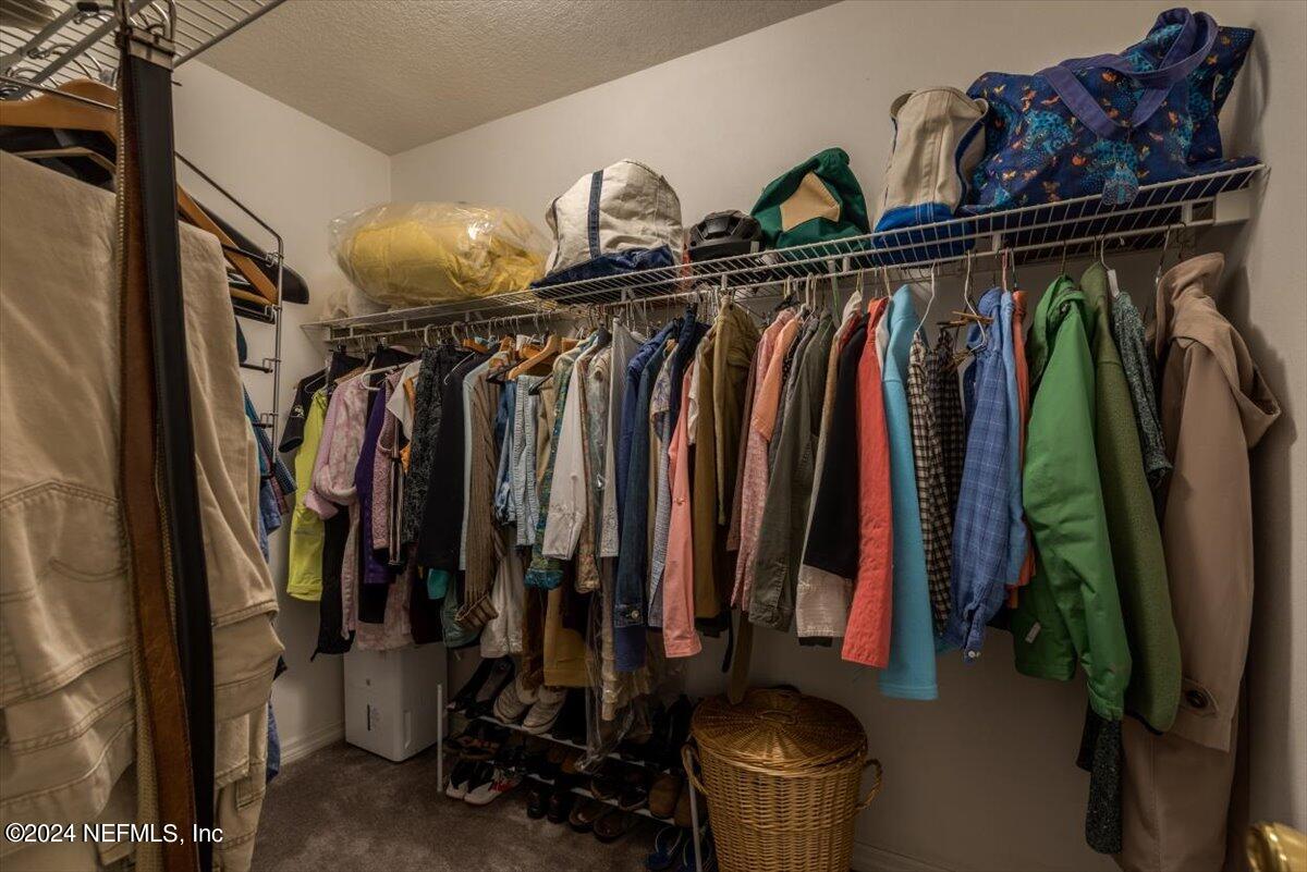 6481 Brooklyn Bay Road Keystone Heights, FL 32656 - Photo 24 of 45 a view of walk in closet with clothes and shoes