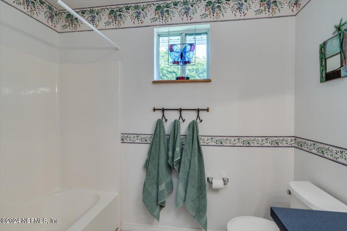 6481 Brooklyn Bay Road Keystone Heights, FL 32656 - Photo 27 of 45 a bathroom with a shower and a toilet