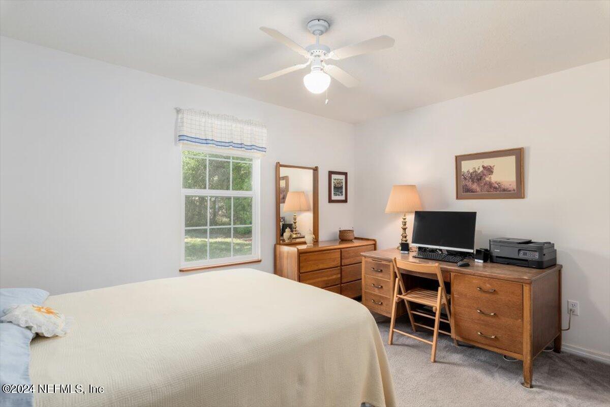 6481 Brooklyn Bay Road Keystone Heights, FL 32656 - Photo 28 of 45 a bedroom with a bed and a desk