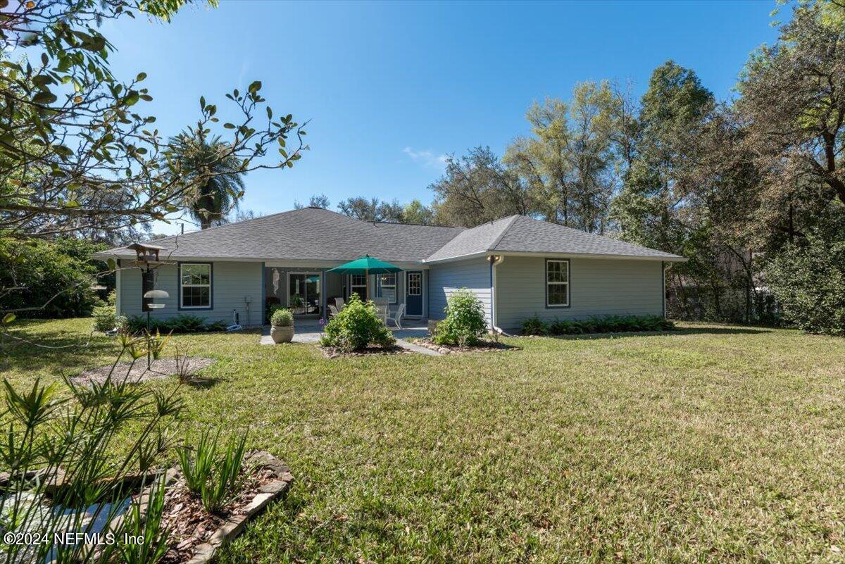 6481 Brooklyn Bay Road Keystone Heights, FL 32656 - Photo 38 of 45 a front view of a house with a yard and trees