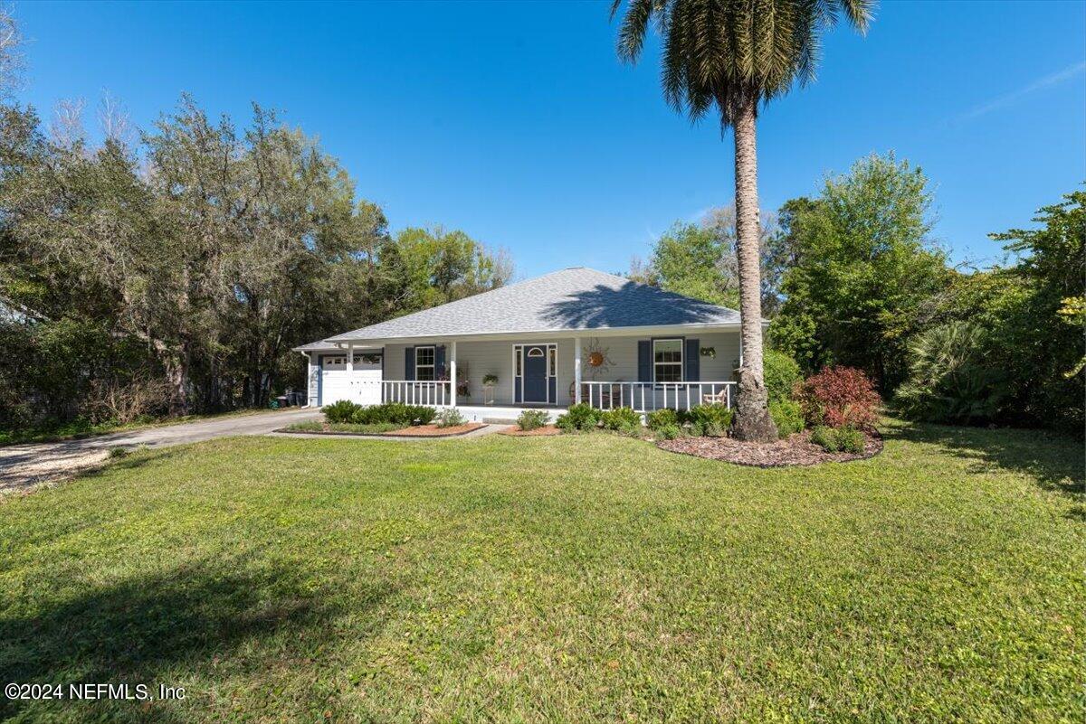 6481 Brooklyn Bay Road Keystone Heights, FL 32656 - Photo 40 of 45 a front view of a house with garden