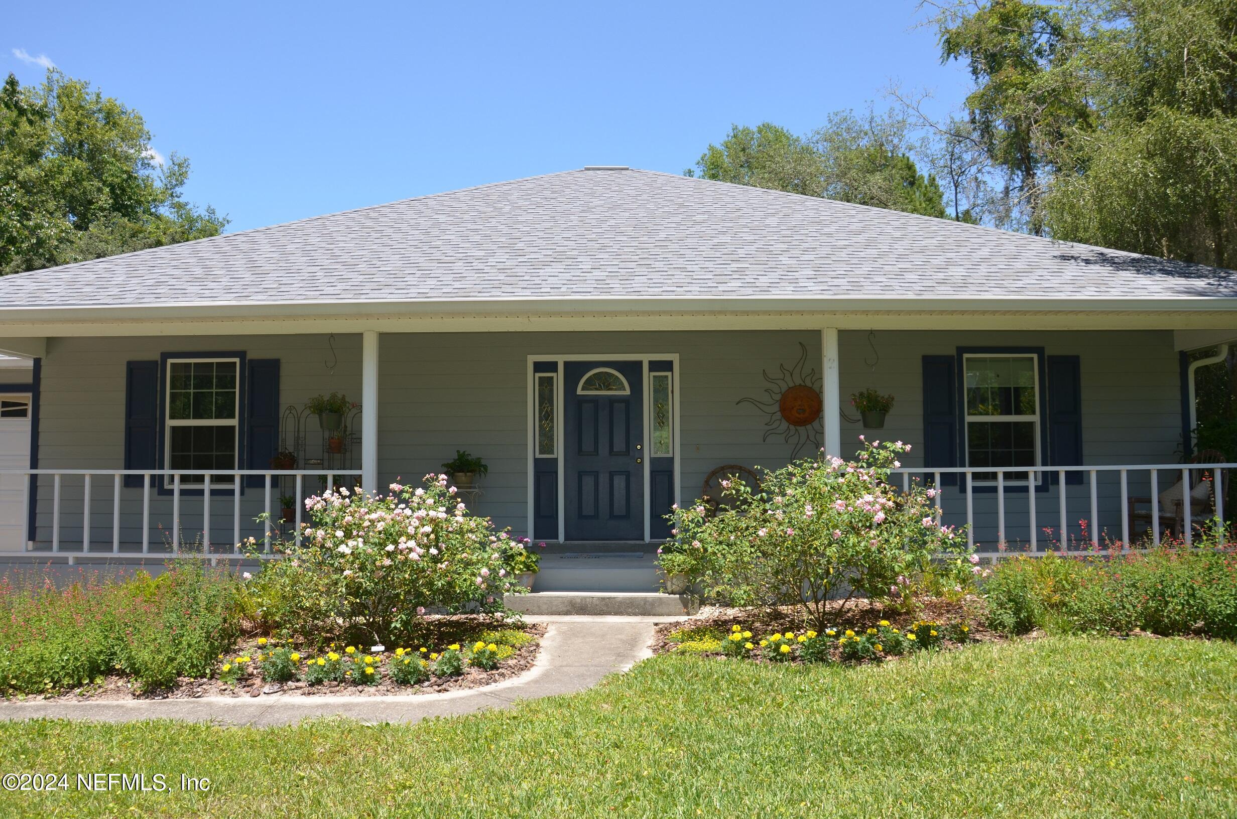 6481 Brooklyn Bay Road Keystone Heights, FL 32656 - Photo 42 of 45 a front view of a house with a yard