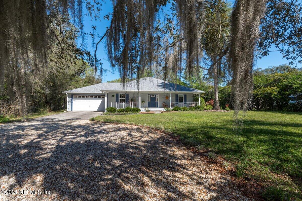 6481 Brooklyn Bay Road Keystone Heights, FL 32656 - Photo 5 of 45 a front view of a house with a yard