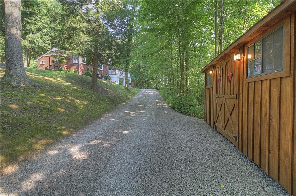 687 Park Road Beaver Falls, PA 15010 - Photo 18 of 22 Graveled driveway leads to home and spacious parking area. The second shed is located along the drive.