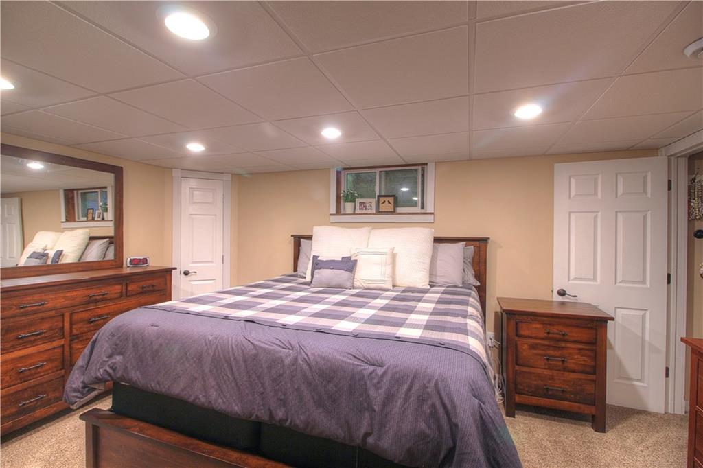 687 Park Road Beaver Falls, PA 15010 - Photo 7 of 22 MASTER BEDROOM located on the lower level. Neutral tones and newer carpet. Chicago grid ceiling. Plenty of room for all of your furniture including a King size bed. Door to the walk-in closet is to the right.