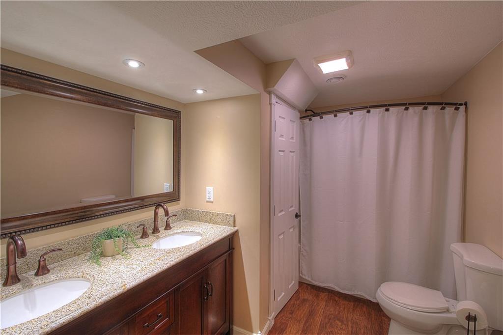687 Park Road Beaver Falls, PA 15010 - Photo 8 of 22 MASTER BATH has double sinks so you don't have to share. Neutral tones with wood cabinetry. Laminate floor.