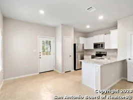 a view of kitchen with stainless steel appliances refrigerator stove microwave and sink