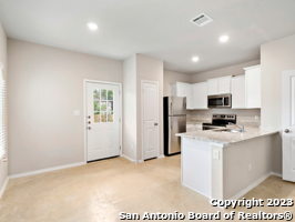 7356 Misty Ridge Drive, Unit 5 Converse, TX 78109 - Photo 15 of 25 a view of kitchen with stainless steel appliances refrigerator stove microwave and sink