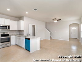7356 Misty Ridge Drive, Unit 5 Converse, TX 78109 - Photo 16 of 25 a kitchen with kitchen island granite countertop a sink cabinets and stainless steel appliances