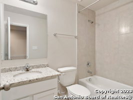 7356 Misty Ridge Drive, Unit 5 Converse, TX 78109 - Photo 3 of 25 a bathroom with a granite countertop sink and a mirror