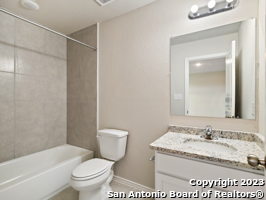 7356 Misty Ridge Drive, Unit 5 Converse, TX 78109 - Photo 4 of 25 a bathroom with a granite countertop sink toilet and shower