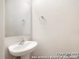 a bathroom with a sink and mirror