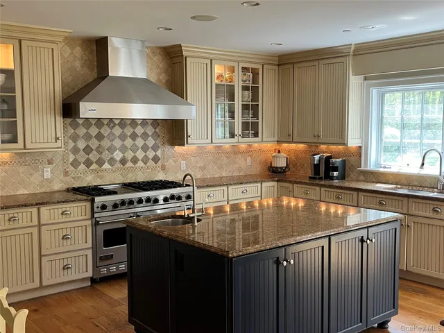 a kitchen with a stove a sink and a cabinets