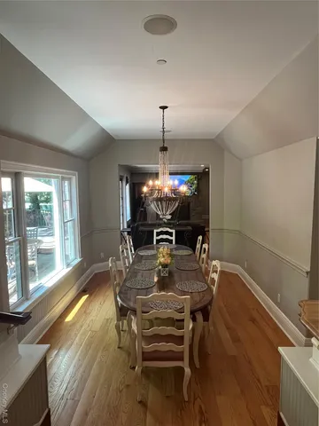 a dining room with furniture and wooden floor