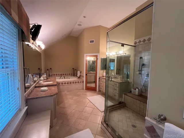 a large bathroom with a large tub and sink