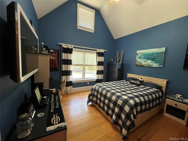 a bedroom with a bed next to a window