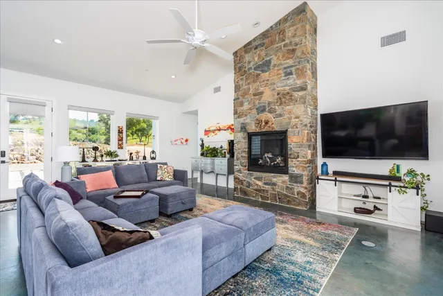 a kitchen with stainless steel appliances kitchen island granite countertop a stove a sink and a refrigerator