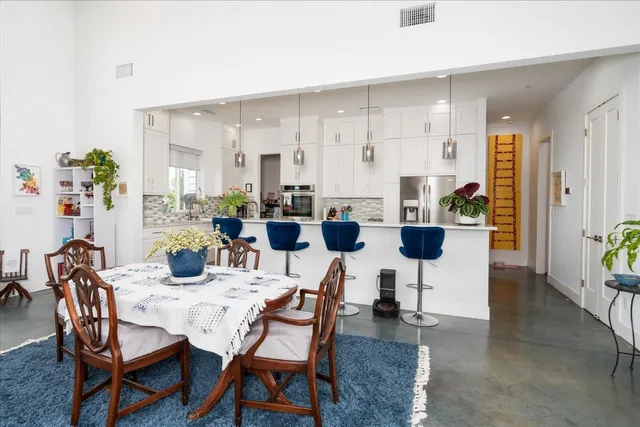 a kitchen with stainless steel appliances granite countertop a sink a stove and cabinets