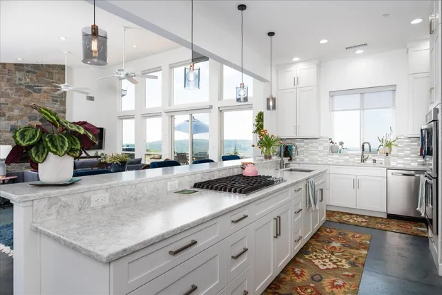 a kitchen with stainless steel appliances white cabinets and a refrigerator