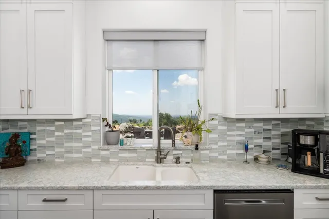 a living room with furniture a rug and a chandelier
