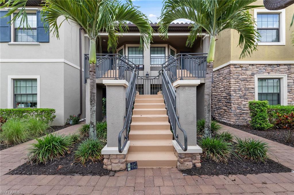 9366 Pocida Court, Unit 202 Naples, FL 34119 - Photo 3 of 44 a front view of house with yard and green space