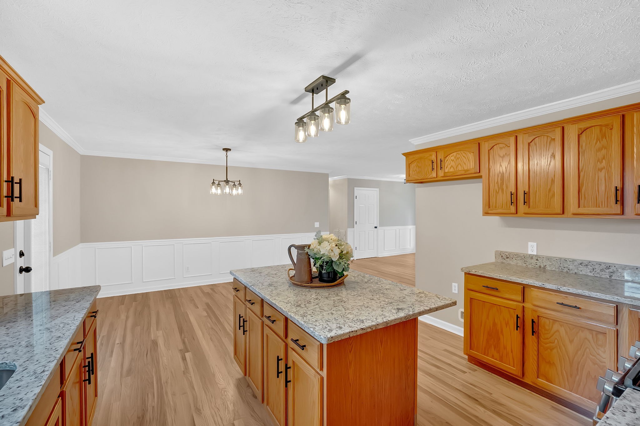 282 Hunt Creek Road Manchester, TN 37355 - Photo 7 of 39 a kitchen with granite countertop cabinets stainless steel appliances a sink and wooden floor