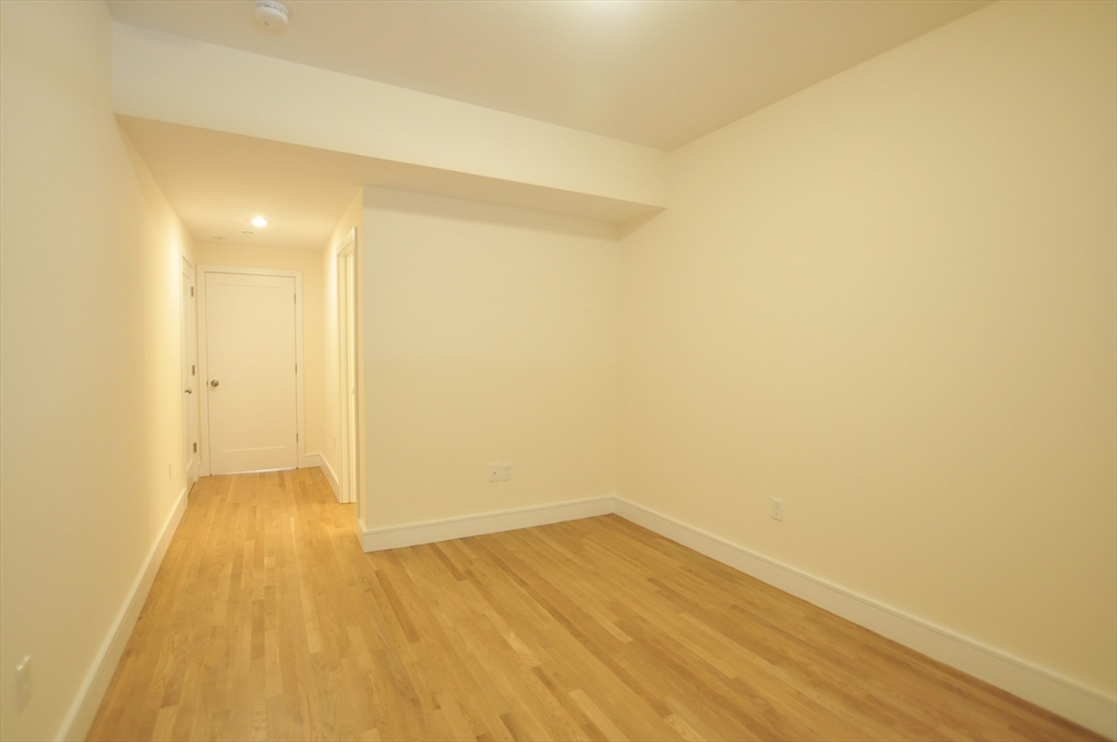877 Beacon Street, Unit 1 Boston, MA 02215 - Photo 5 of 12 a view of an empty room with wooden floor