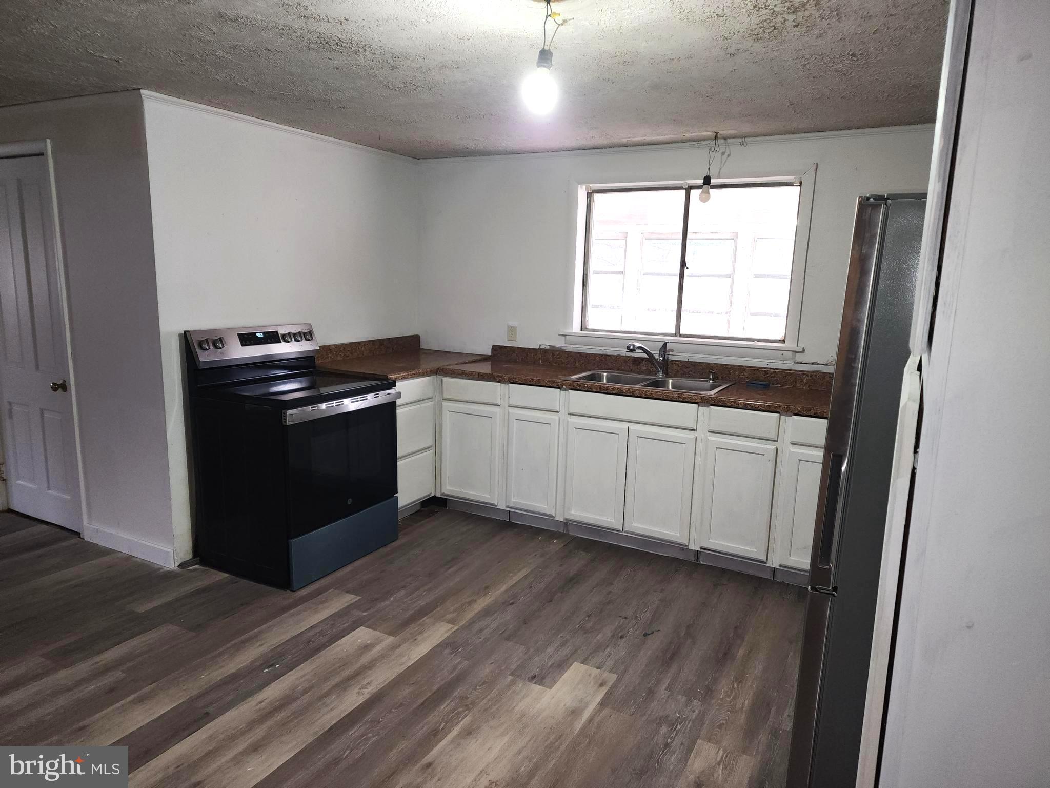 15689 Ridge Road Fort Loudon, PA 17224 - Photo 16 of 24 a kitchen with a sink stove and cabinets