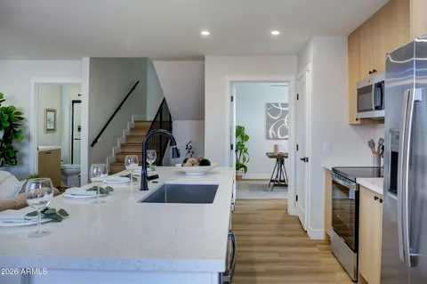 a kitchen with a sink stainless steel appliances and cabinets