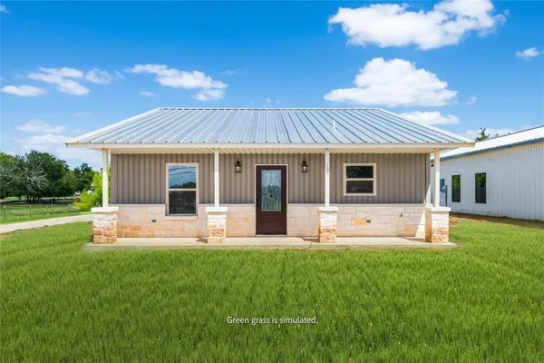 a front view of house with a garden and patio