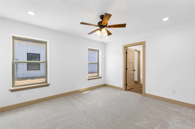 an empty room with closet and a chandelier fan